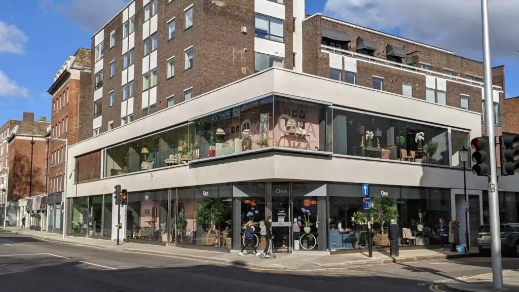 Major Furniture Chain Shuts Down Without Warning, Files Chapter 7 Bankruptcy An exterior view of an OKA store with people walking outside of it.