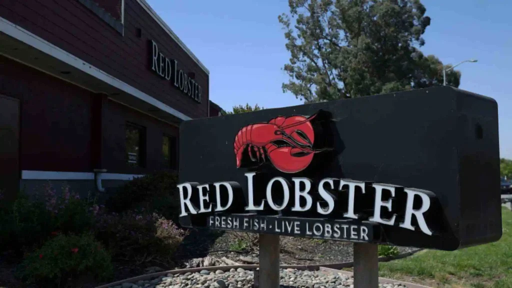 Exterior of a Red Lobster restaurant with a sign that reads "Fresh Fish. Live Lobster."