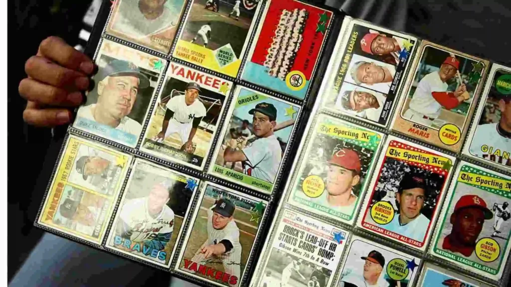 A person holding a binder full of various baseball cards