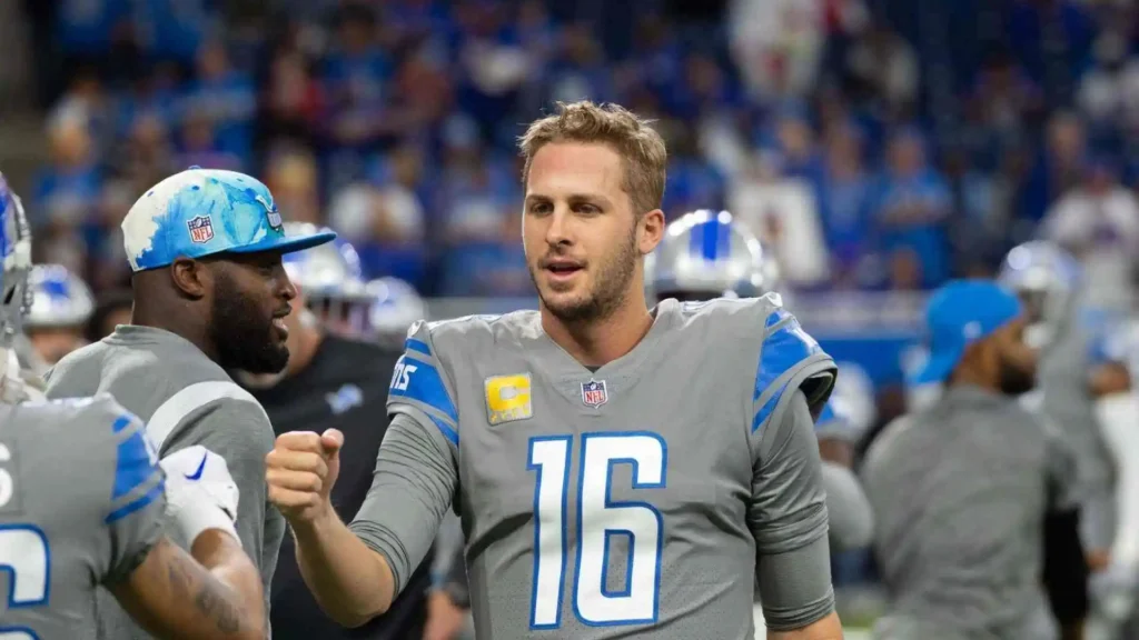 Jared Goff interacting with teammates on the sidelines