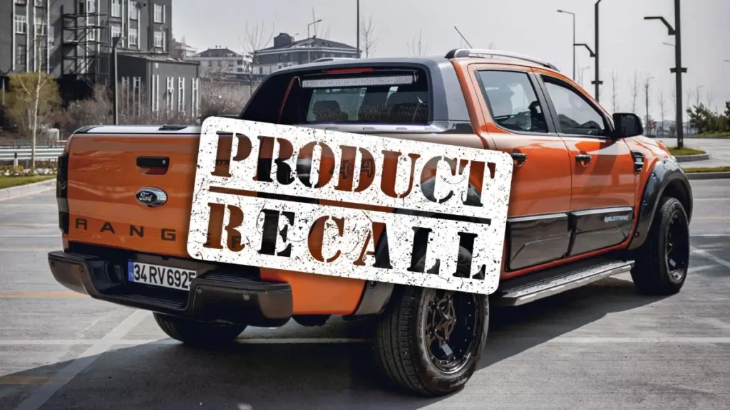 U.S. Government Launches Investigation Into Recent Ford Recalls Orange Ford Ranger Pickup Truck in Parking Lot With a Product Recall Sticker Over it